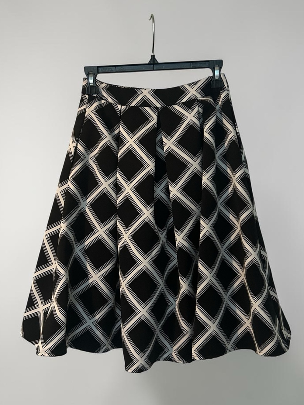 Express black and white plaid midi skirt with a flowy, A-line silhouette